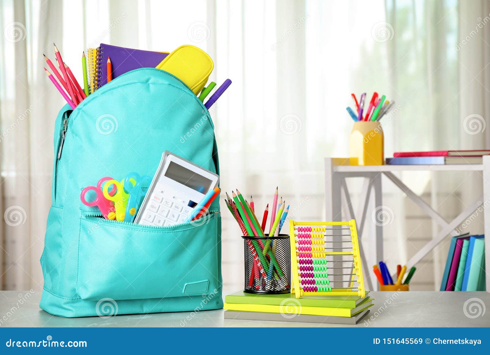 Bright Backpack and School Stationery on Table Indoors Stock Image
