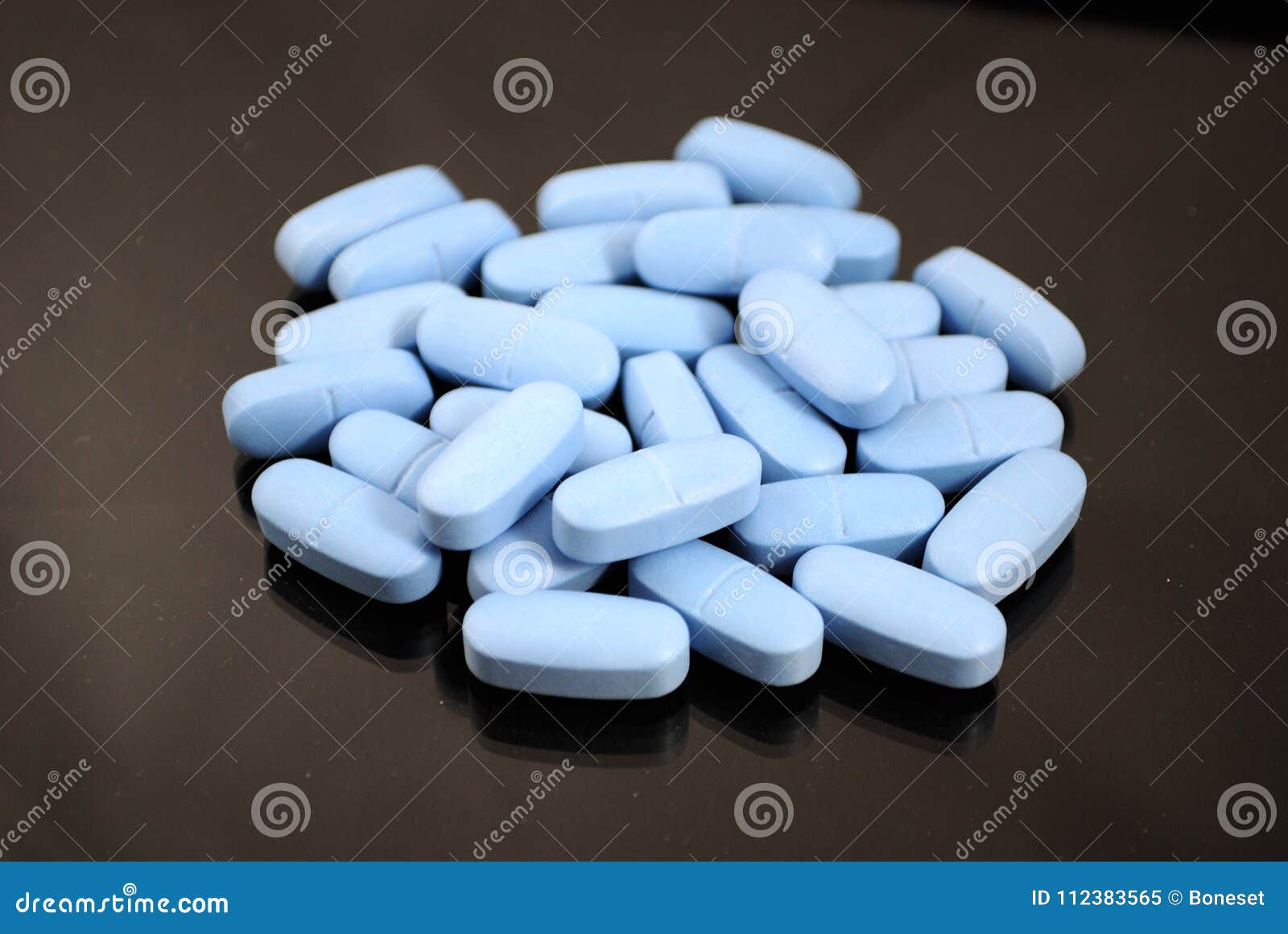 Bright blue oval tablets stock image. Image of medicament 112383565
