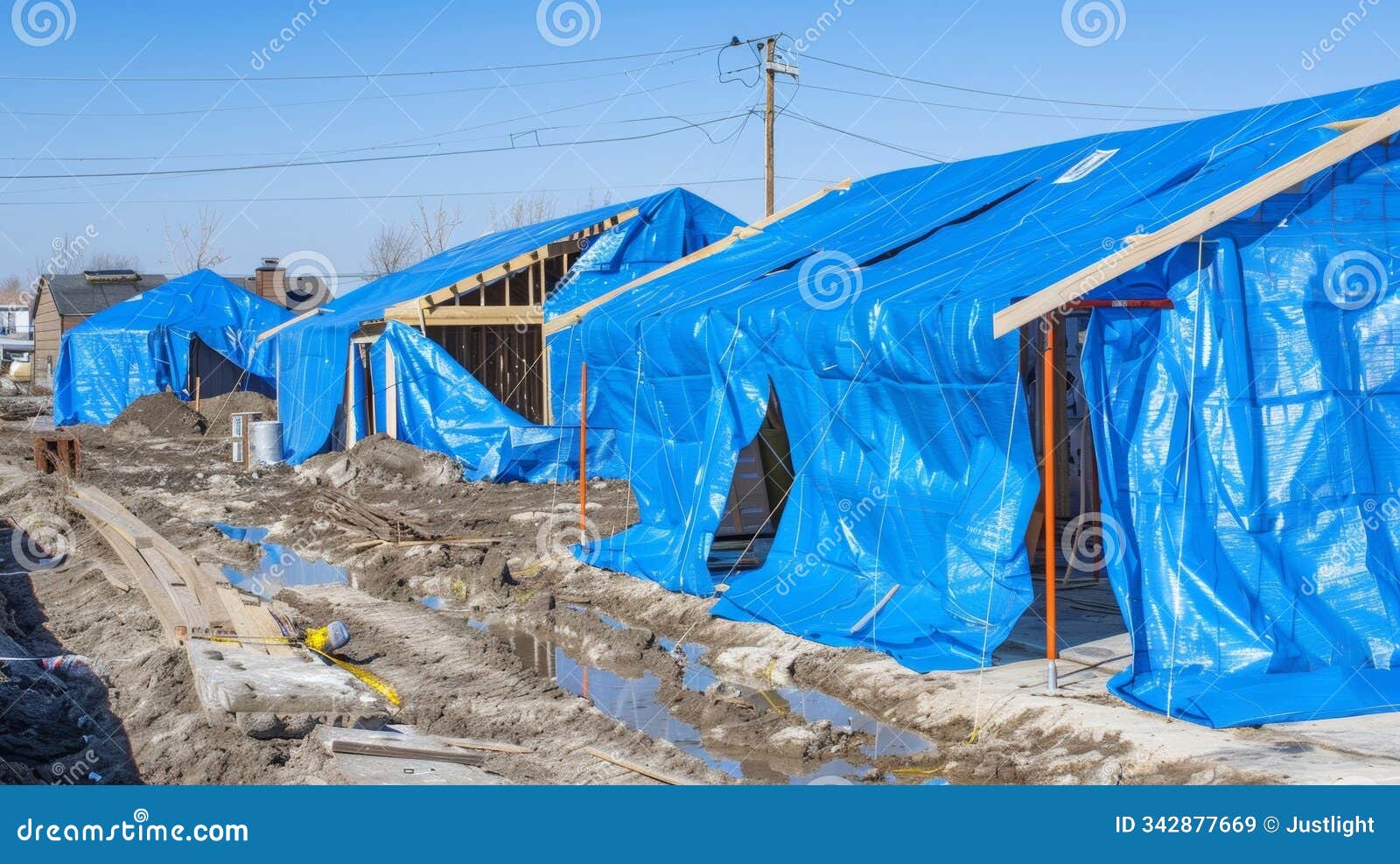 bright blue tarps cover partially built structures protecting them from the s