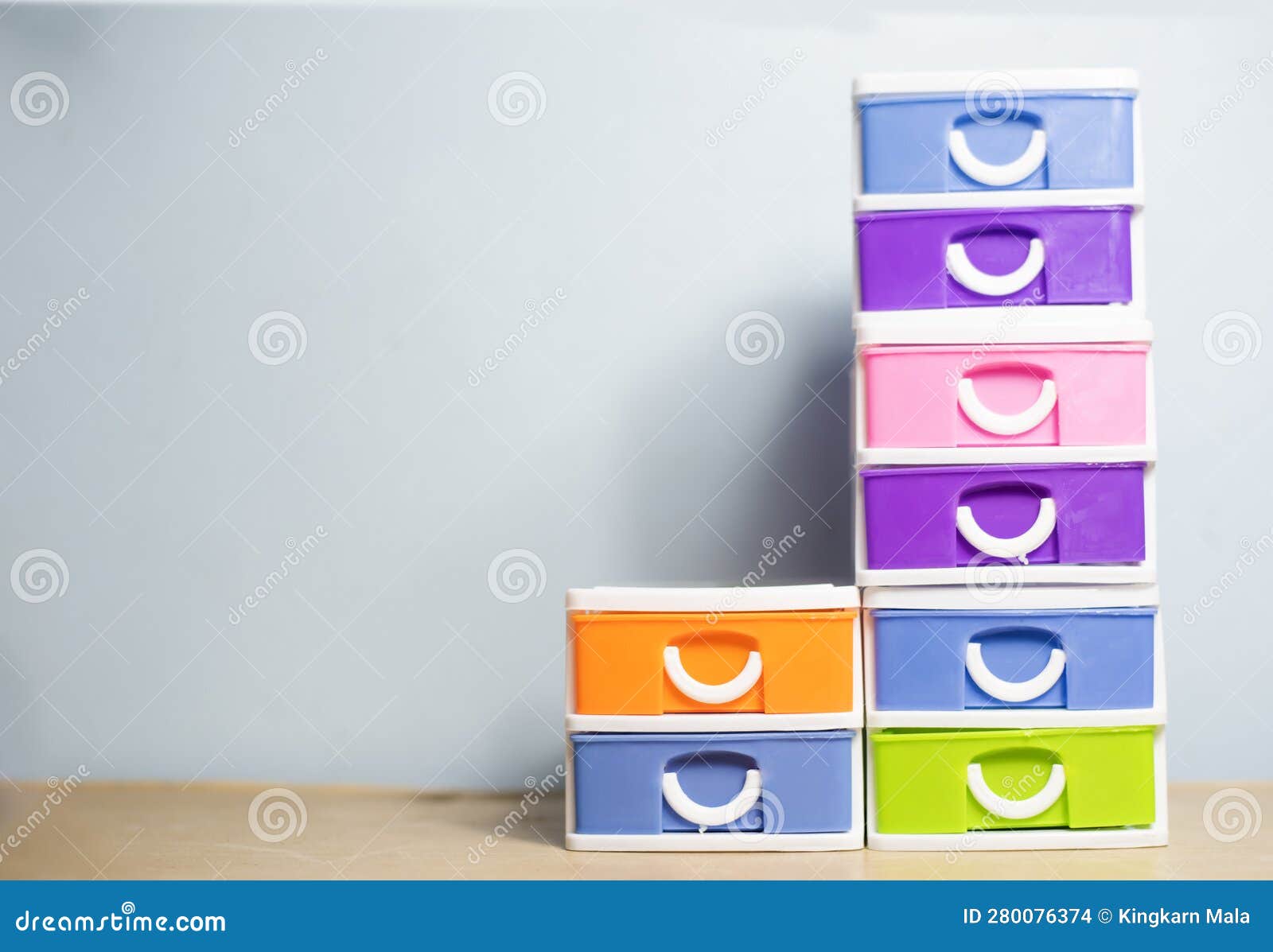 Bright Colored Plastic Drawers, Light Blue Wall Face Stock Photo