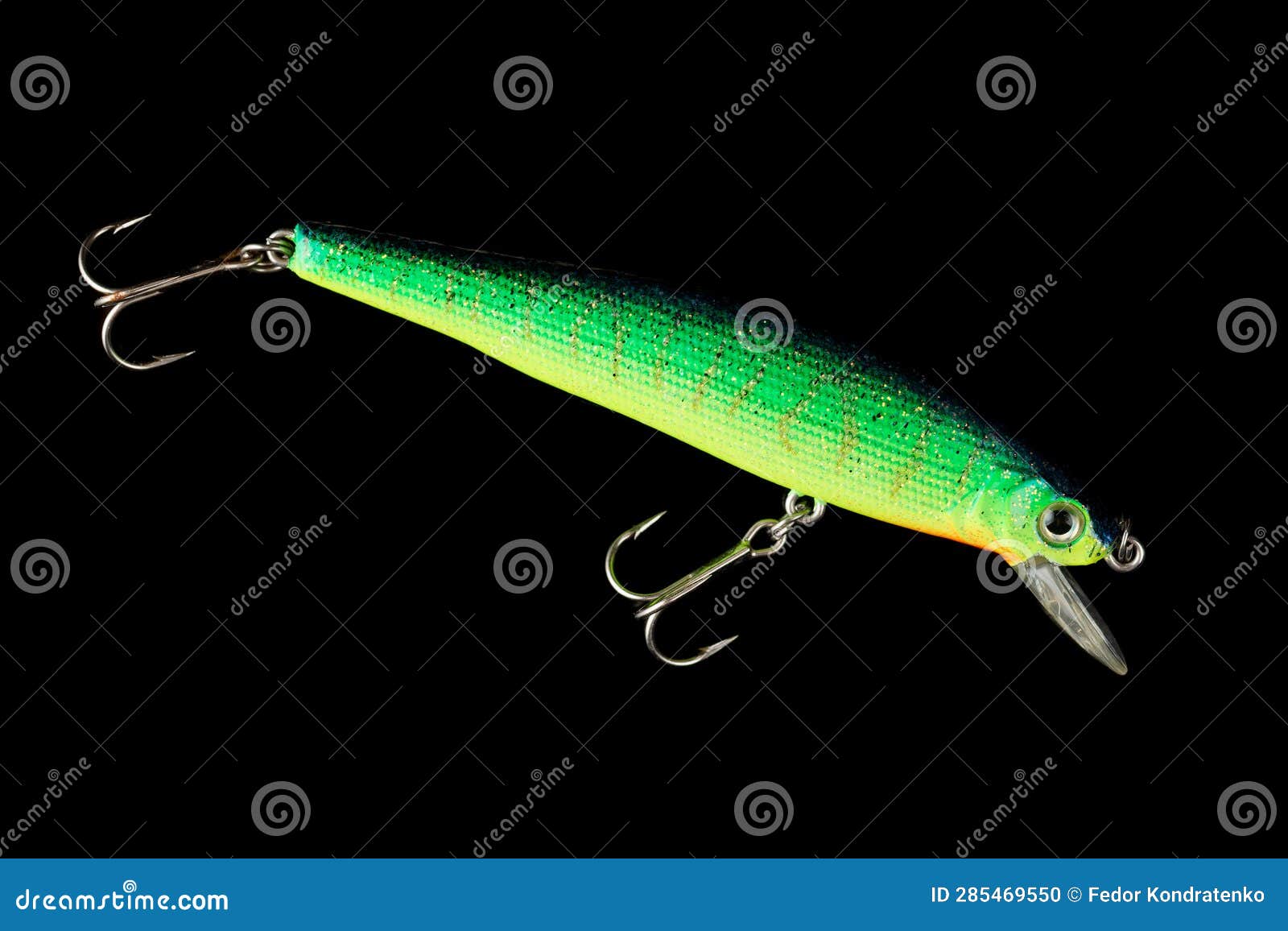 Bright Green Minnow Plastic Fishing Lure Isolated on Black Stock