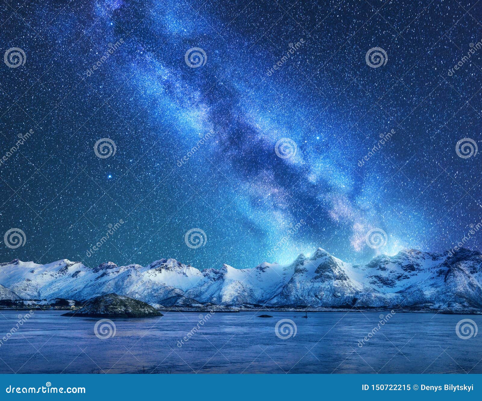 bright milky way over snow covered mountains and sea at night