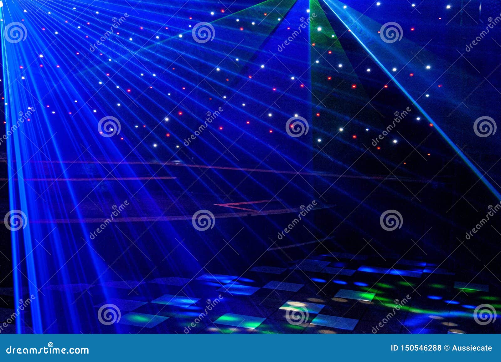 bright nightclub purple, white, blue laser lights cutting through smoke machine smoke making light and rainbow patterns