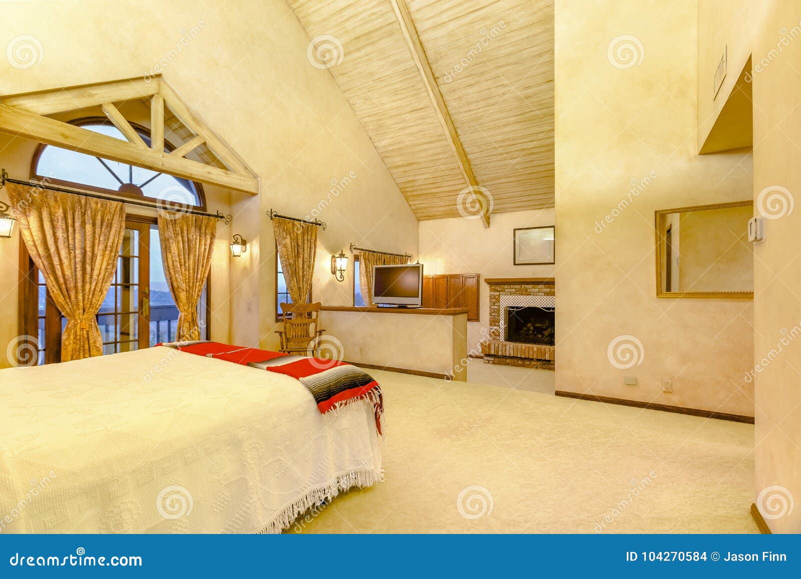 Bright Open And Warm Master Bedroom With Vaulted Ceilings
