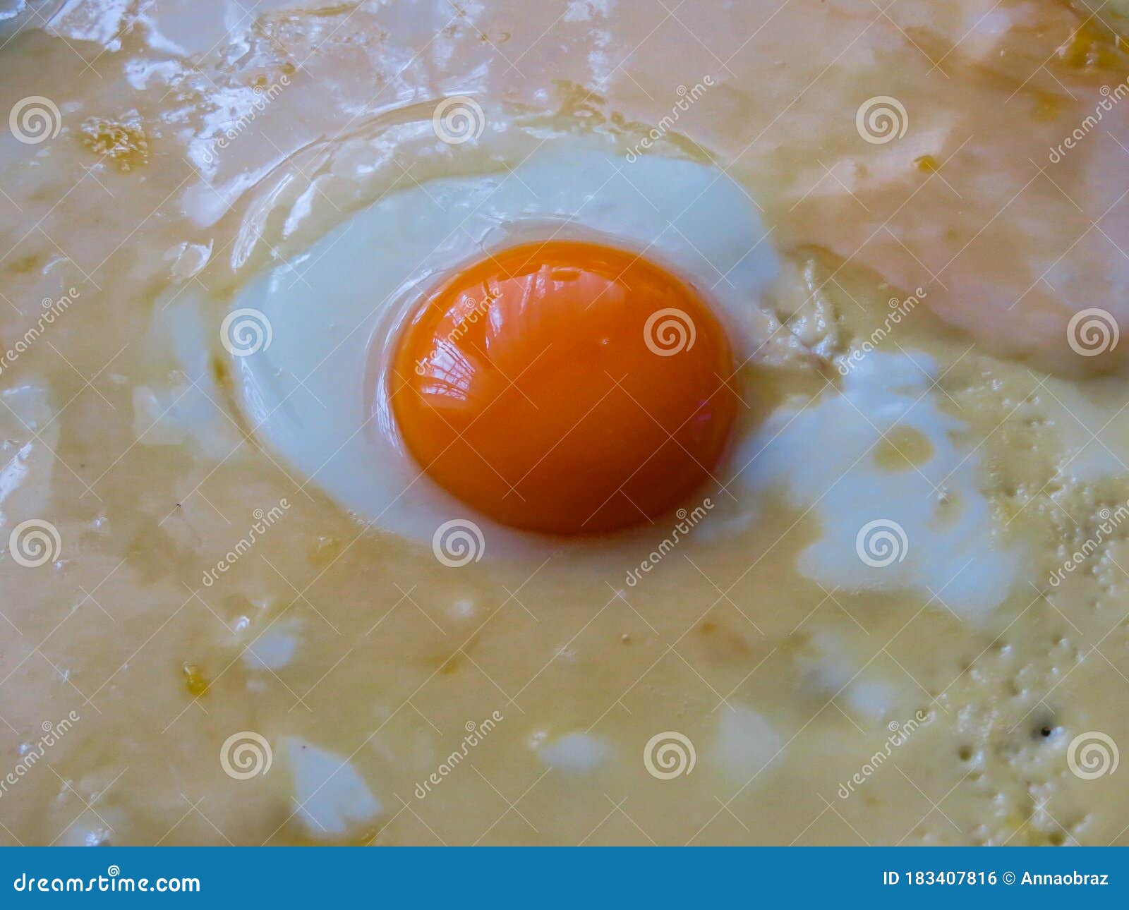 Bright Orange Chicken Yolk in the Center of the Pan in an Omelet Stock