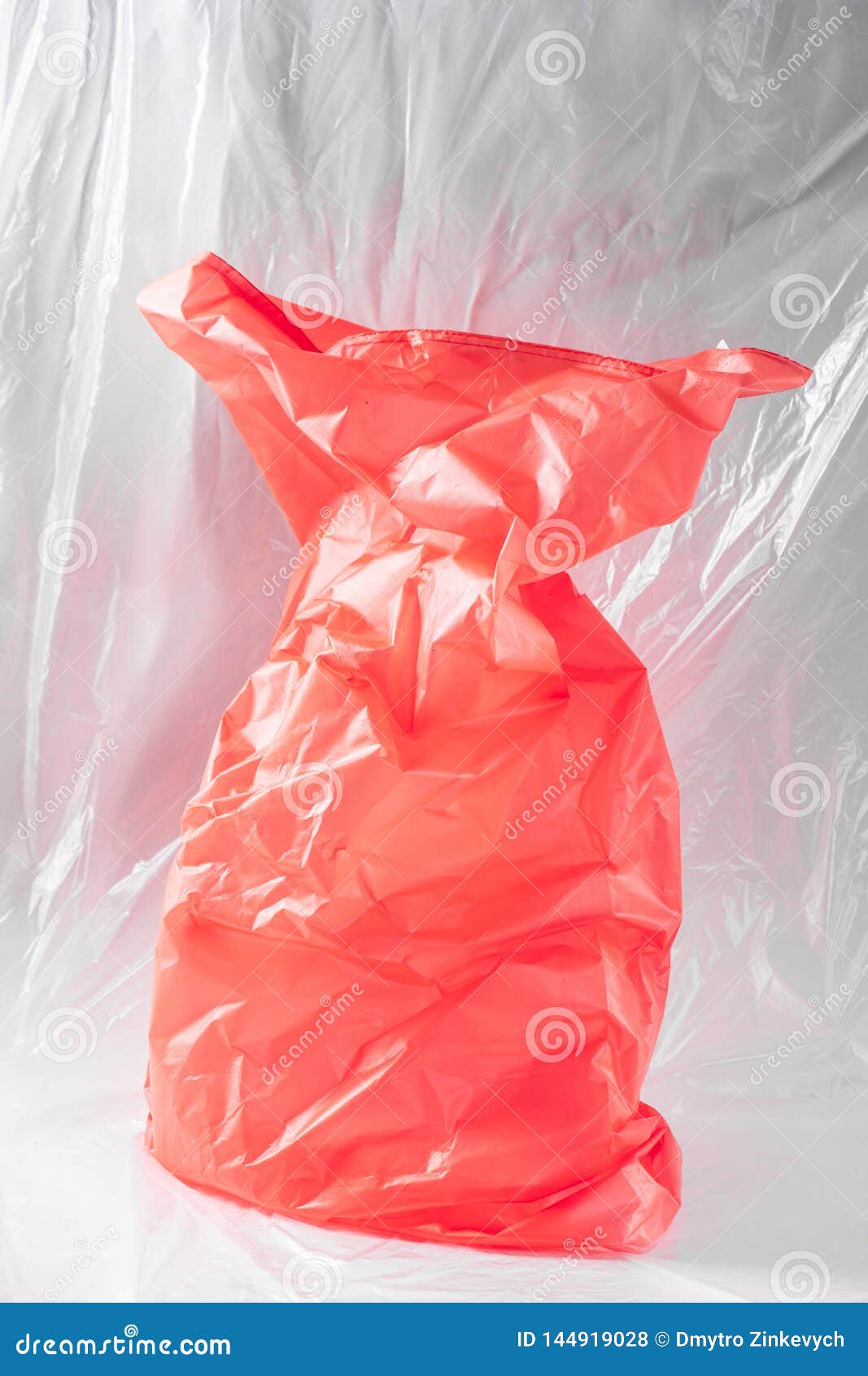 Bright Red Plastic Bag Placed in the Middle of the Studio Stock Photo