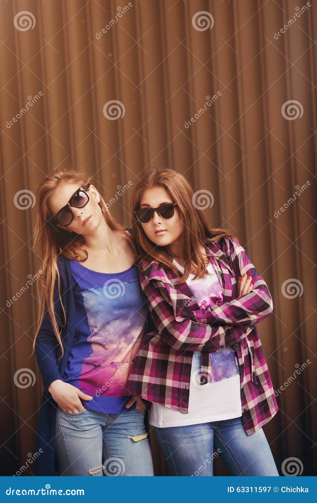 Fashion portrait of two friends posing. modern lifestyle. two stylish sexy  hipster girls best friends ready for party. Two young girl friends standing  together and having fun. Stock Photo by ©zamuruev 152741046
