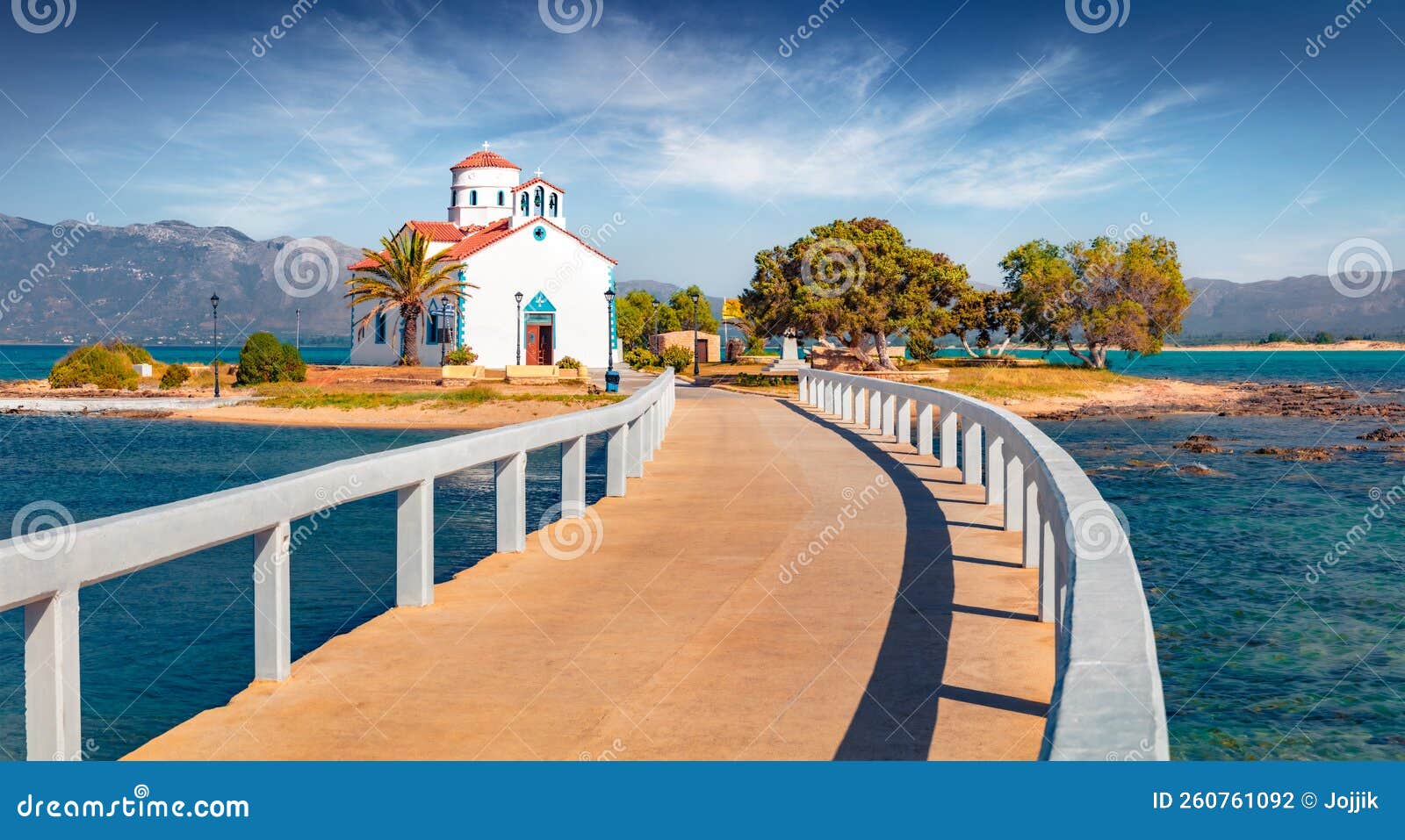 bright summer view of saint spiridon greek orthodox church and walking bridge.