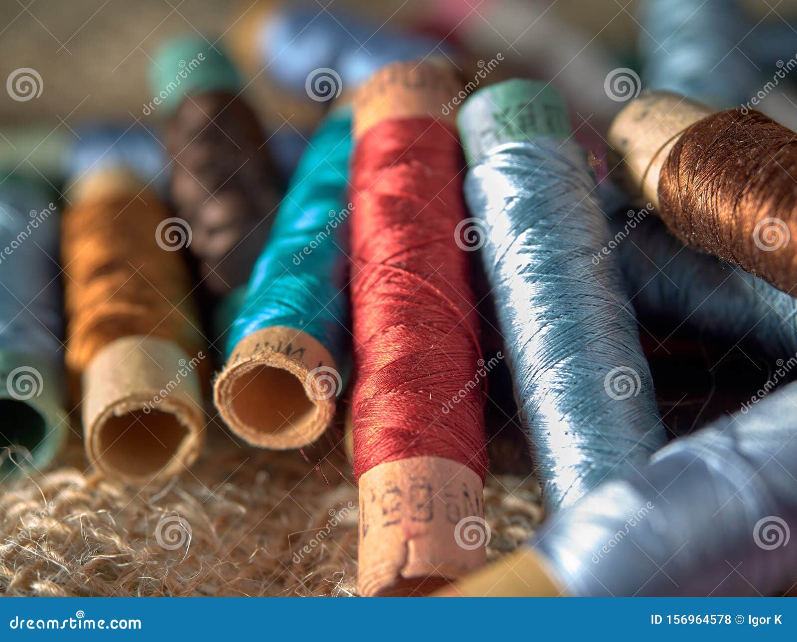 Bright Thread on Wooden Spools, Thimbles and Needles Stock Photo ...