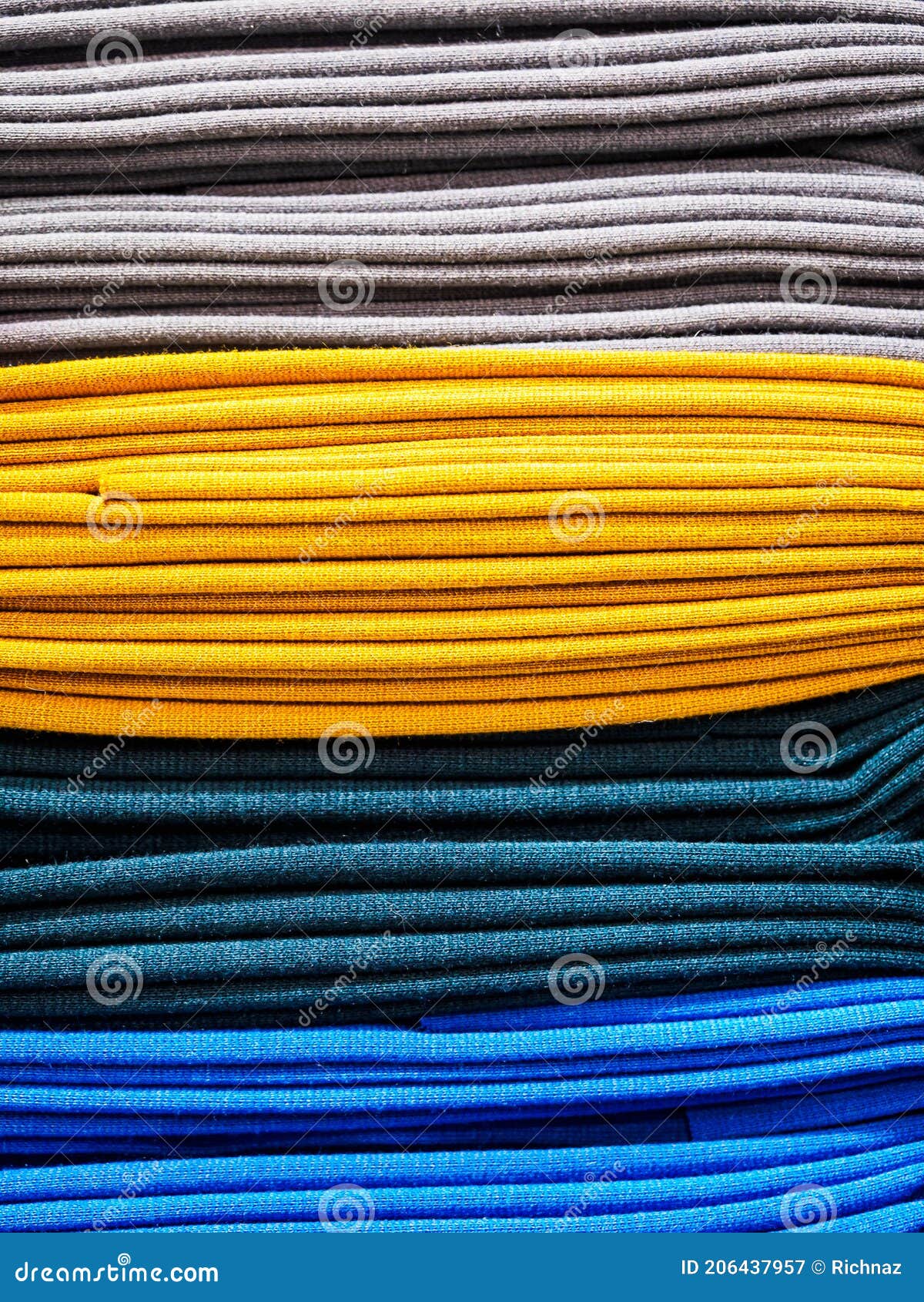 Bright Yellow and Blue Fabric Laid in Layers, Closeup. Background with a Bright and Expressive