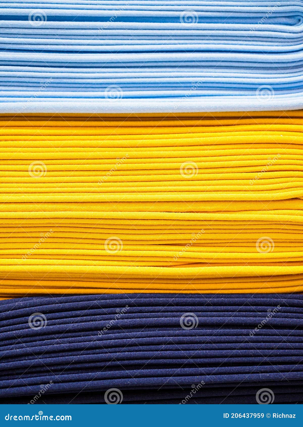 Bright Yellow and Blue Fabric Laid in Layers, Closeup. Background with a Bright and Expressive