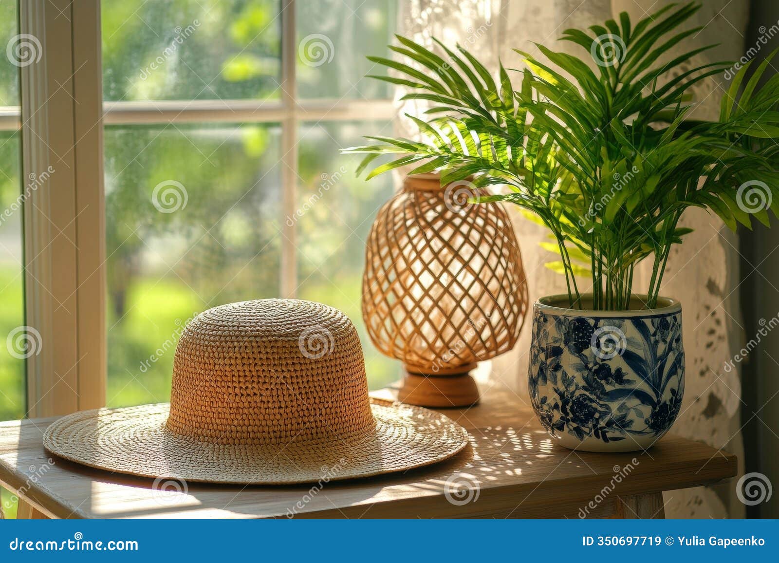 brightly lit indoor corner featuring a woven lamp, plant, and straw hat creating a cozy atmosphere