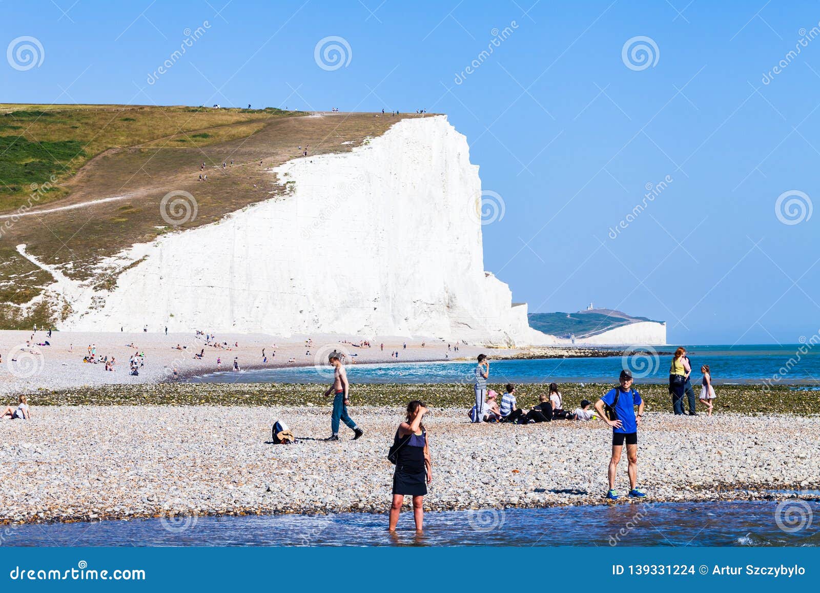 Brighton, UK - June 2018 People Relaxing on the Pebbled Shore Coastline ...