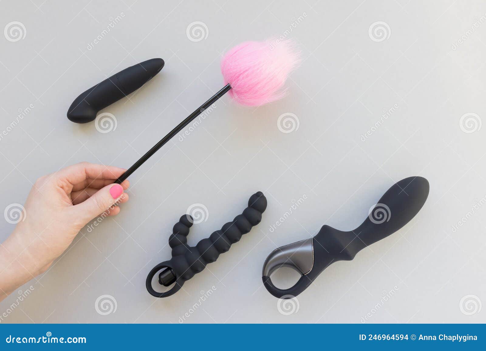 Brinquedos Sexuais Com Penas, Palito De Provocação E Mão Feminina Foto de Stock