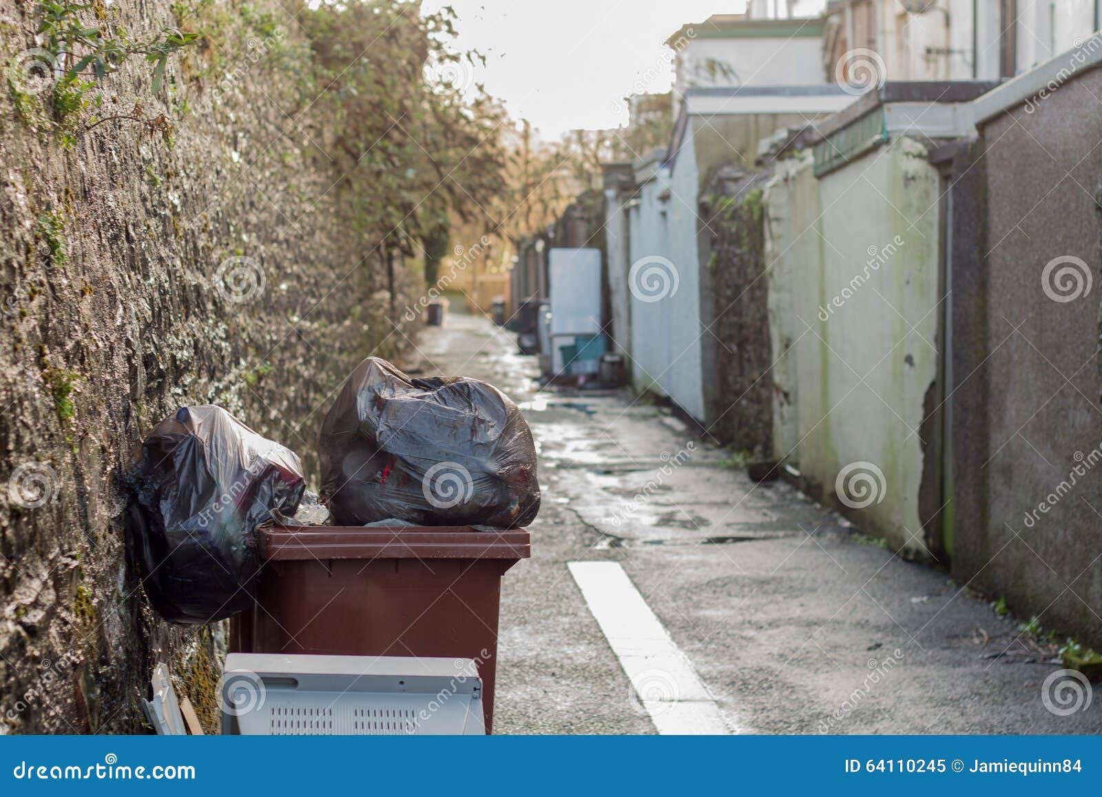 british backstreet with waste bins