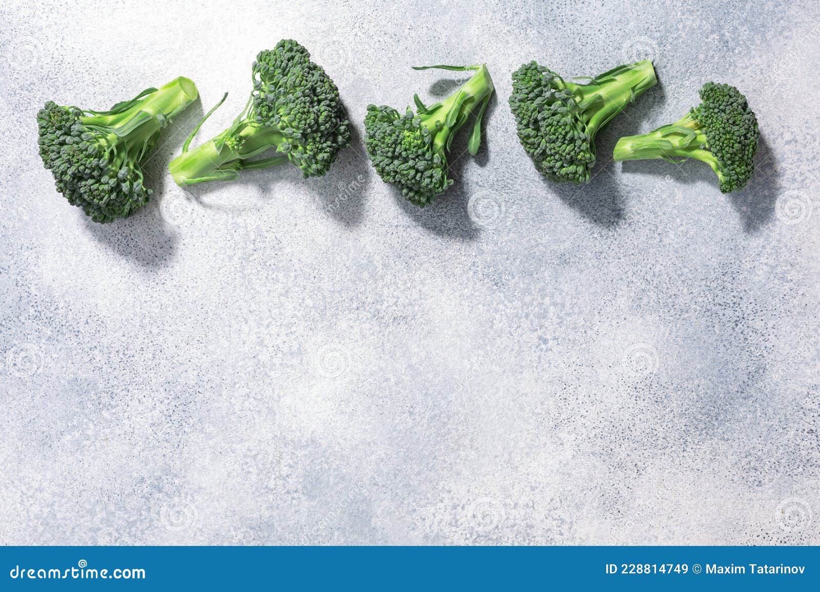 Broccoli Flower Heads Atop Light Grey Textured Backdrop, Copy Space