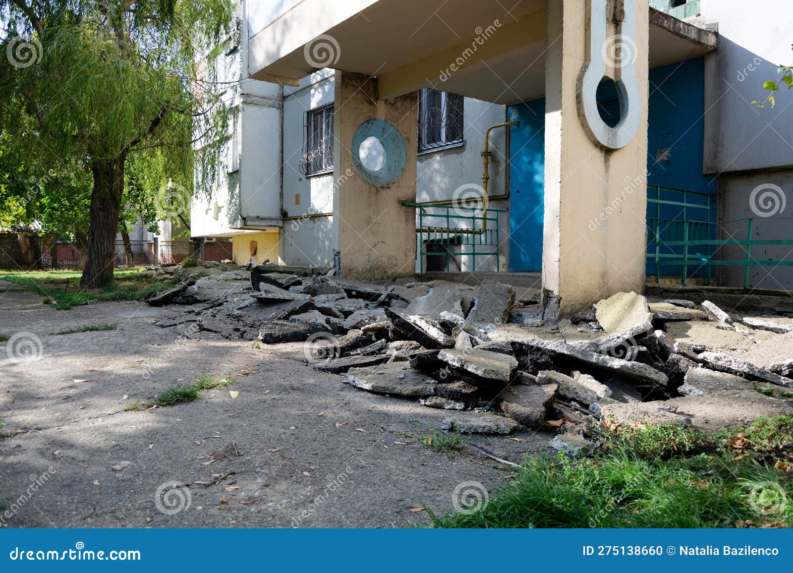 Broken Asphalt Pavement. Broken Blind Area of an Apartment Building