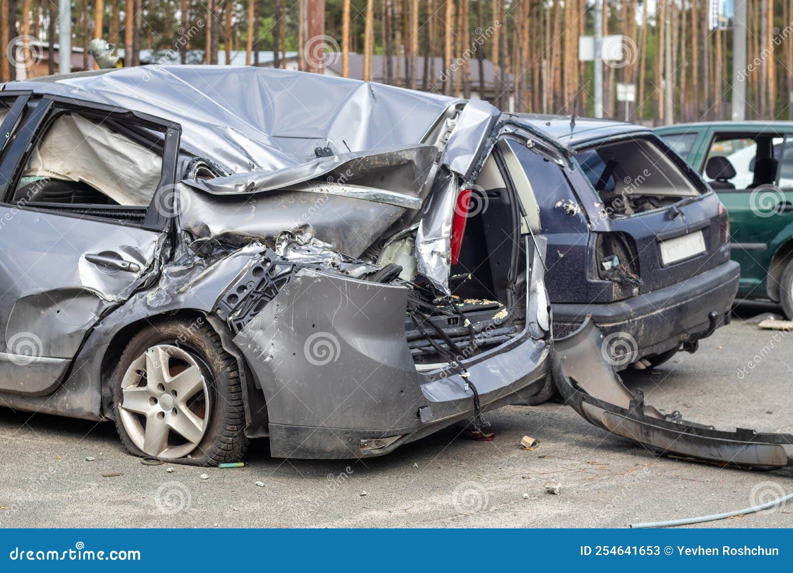 Many broken cars after a traffic accident in the parking lot of a  restoration service station on the street. Car body damage workshop  outdoors. Sale of insurance emergency vehicles at auction. 8281183