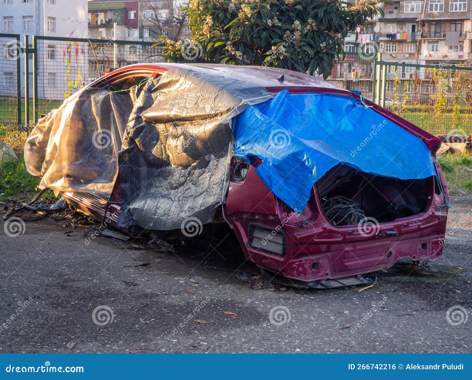 Broken Car Under the Covers. Red Car after the Accident Stock Photo