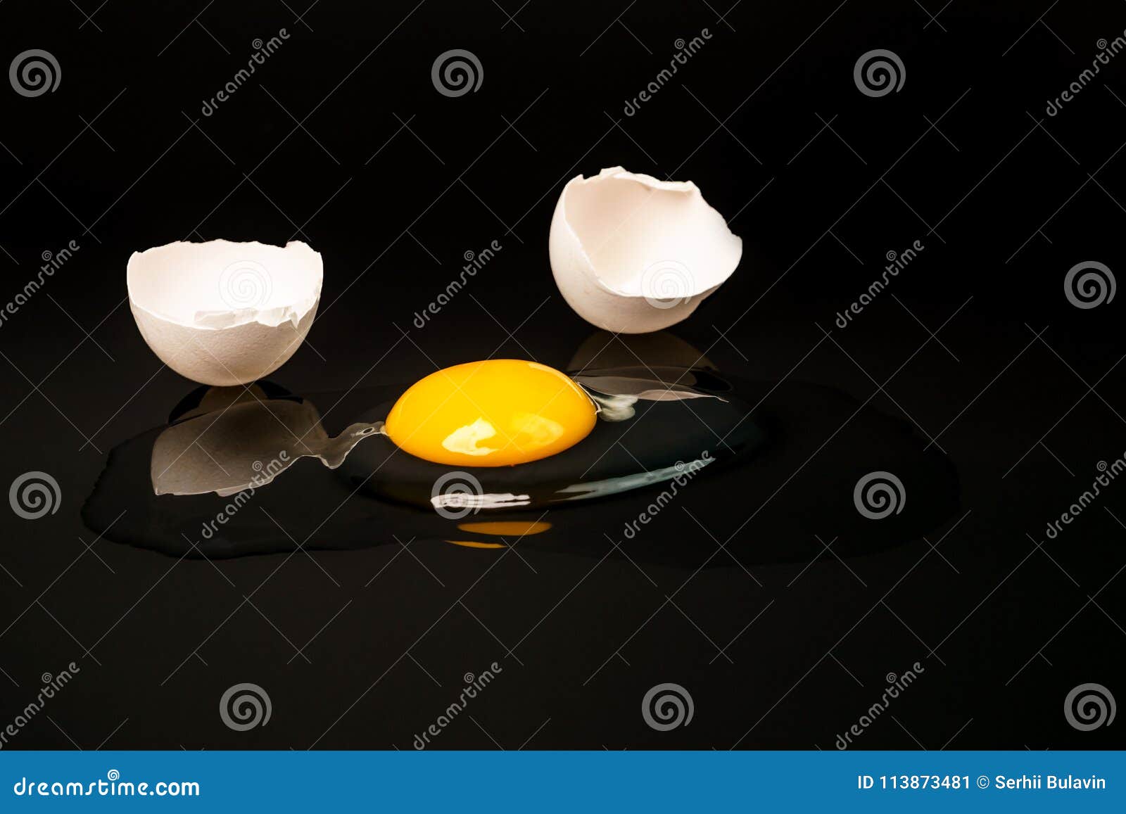 Broken Egg Isolated On The Black Background. Broken Egg On Black Stock