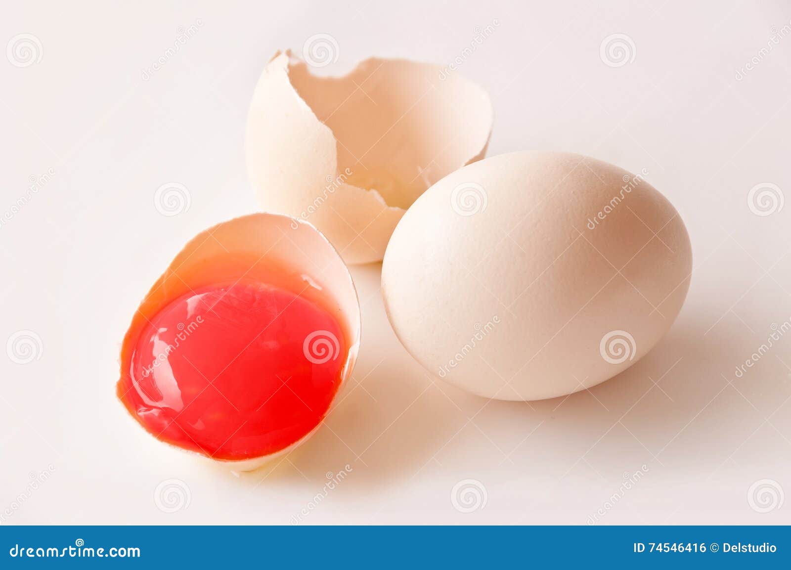 Broken egg with red yolk stock photo. Image of colourful 74546416