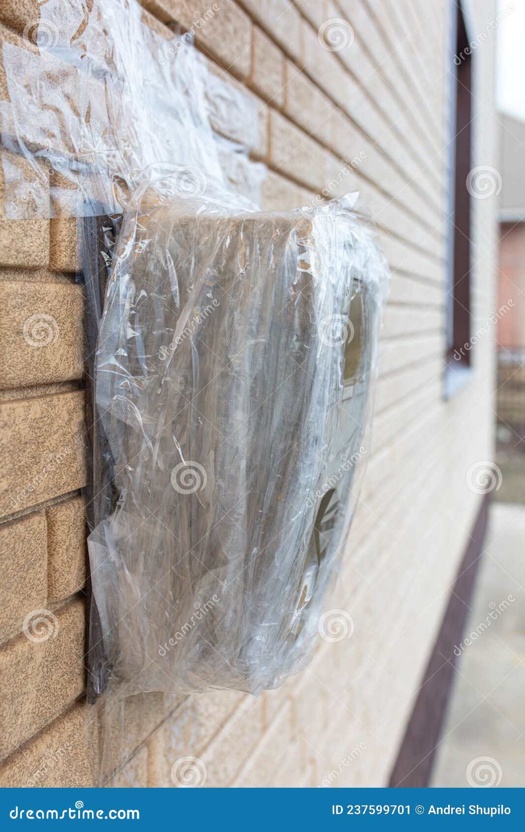Broken Electric Meter Wrapped in Duct Tape on the Wall Stock Image