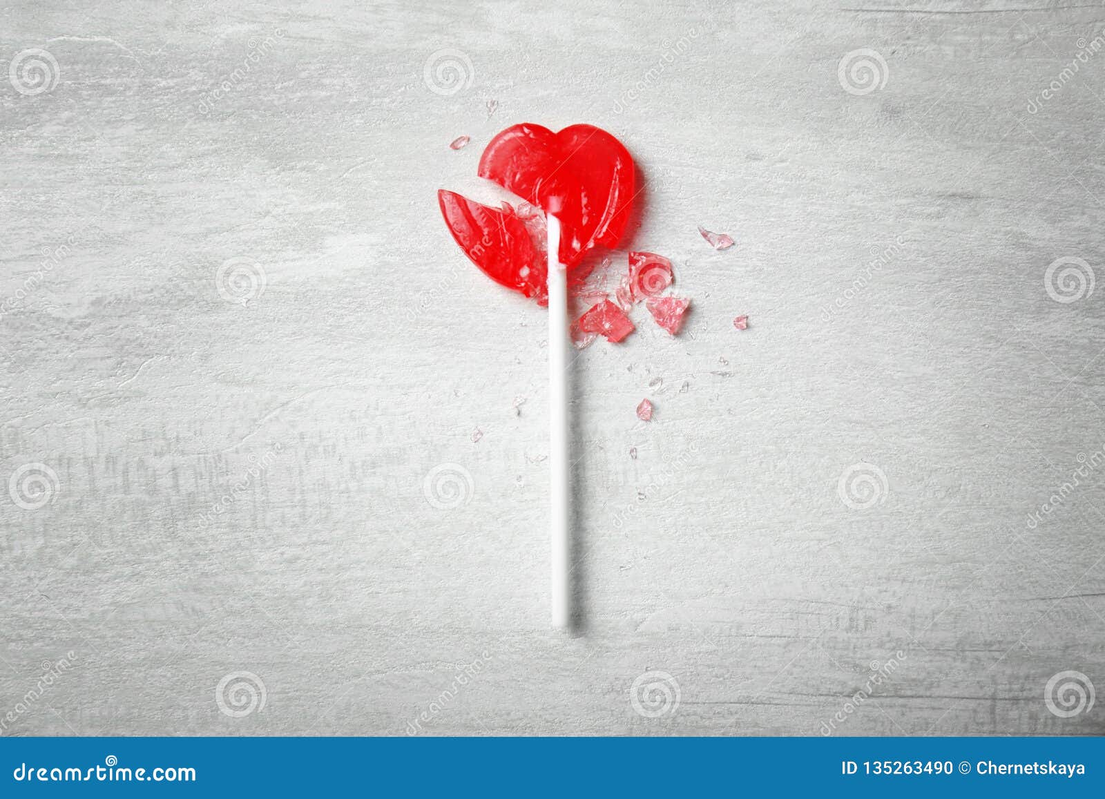 Broken Heart Shaped Lollipop on Gray Background, Top View Stock Photo ...