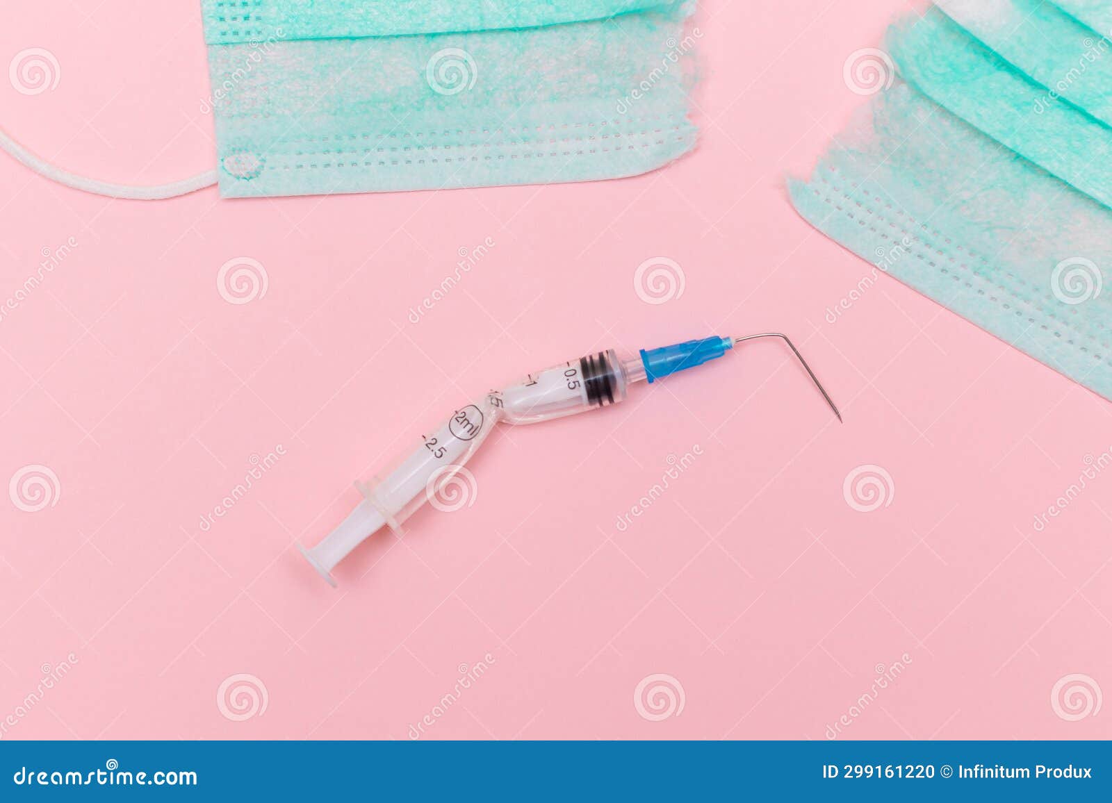 broken medical syringe and torn medical face mask on the pink background
