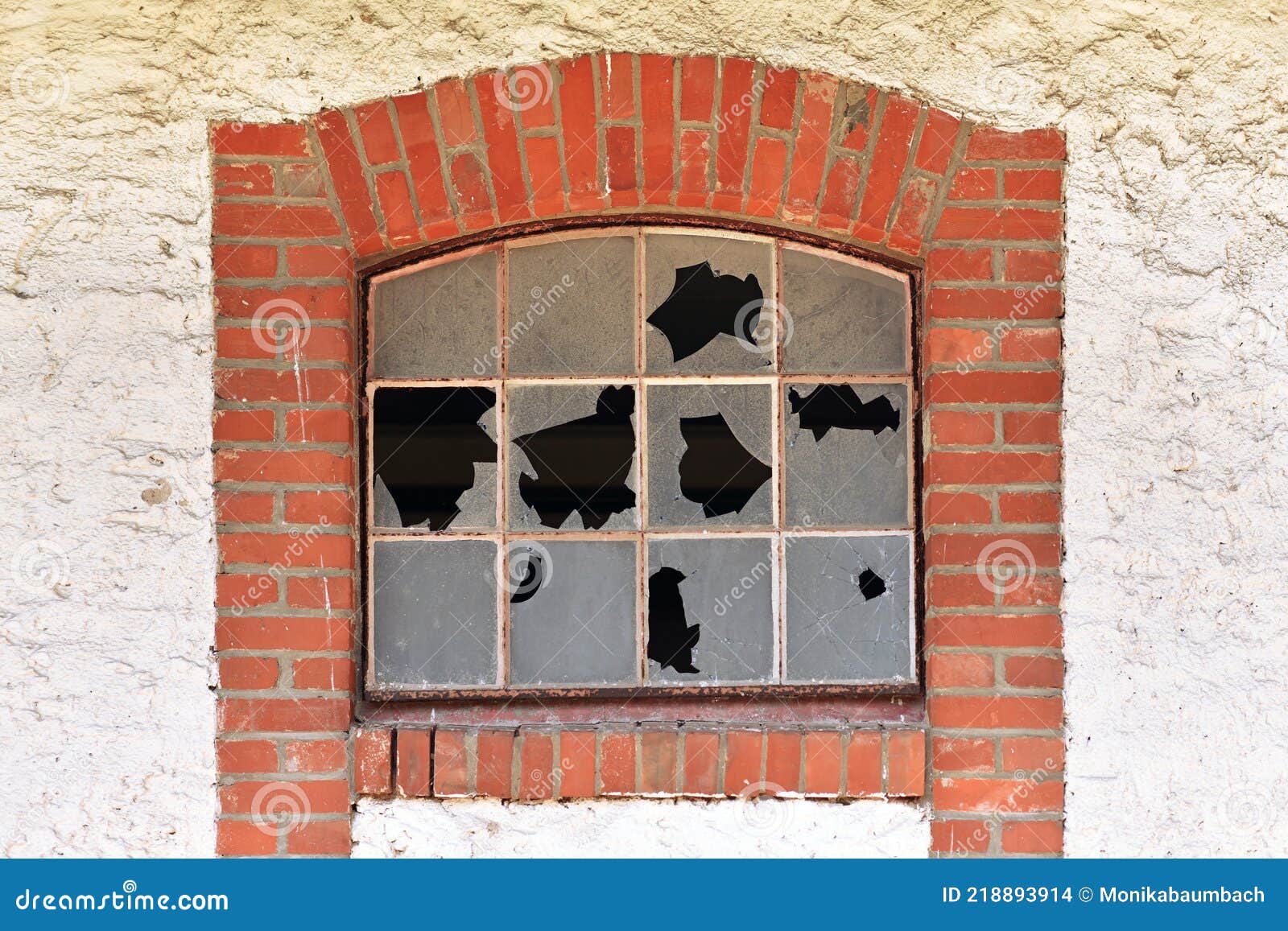 broken muntin window with shattered glass of old abandoned building