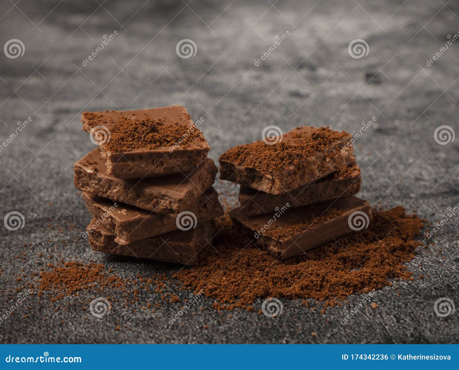 Broken Pieces of Chocolate Sprinkled with Coffee Powder Close Up Stock