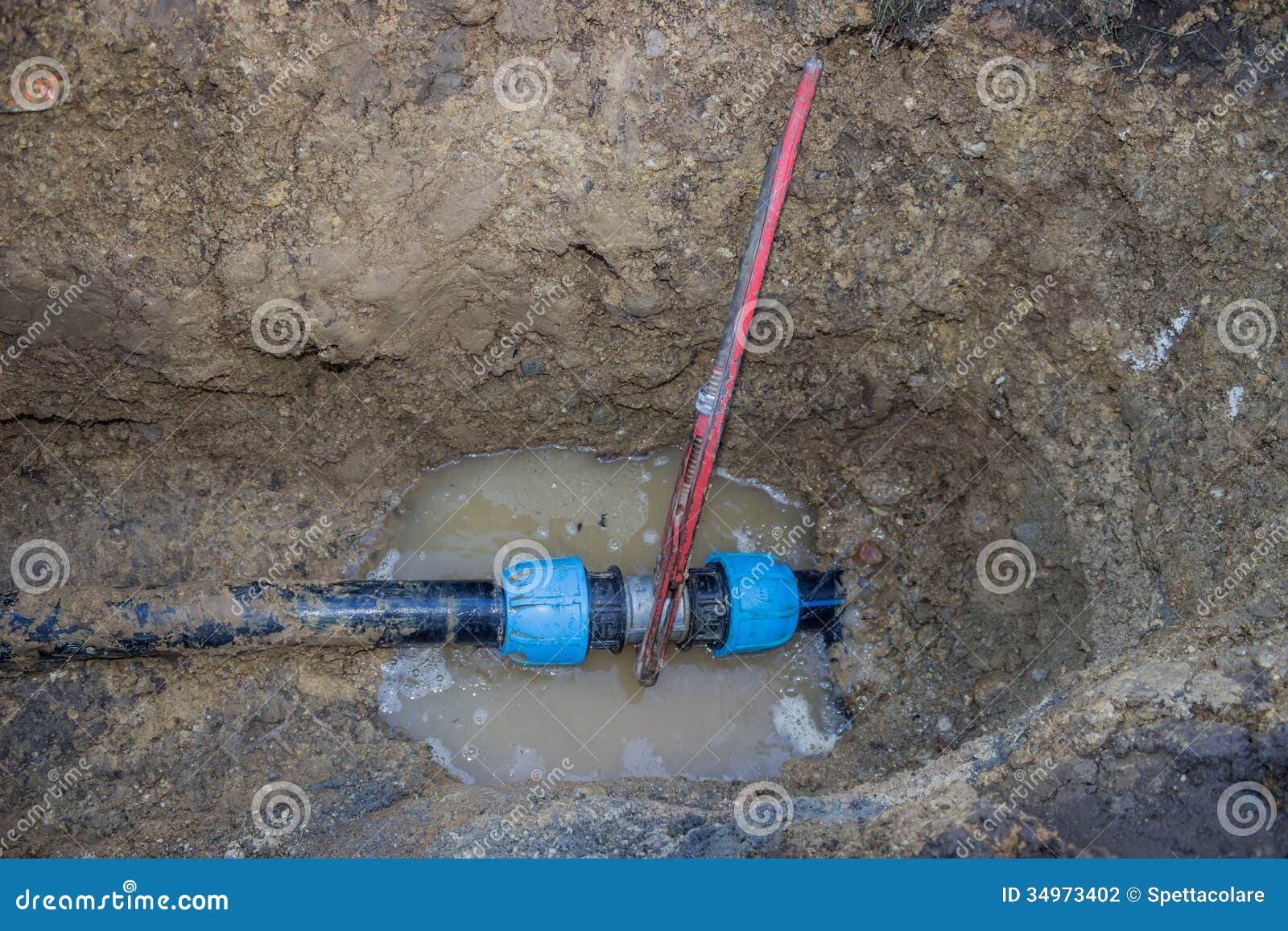 Broken Pvc Pipe in Trench with Wrench Leaks Water Stock Photo