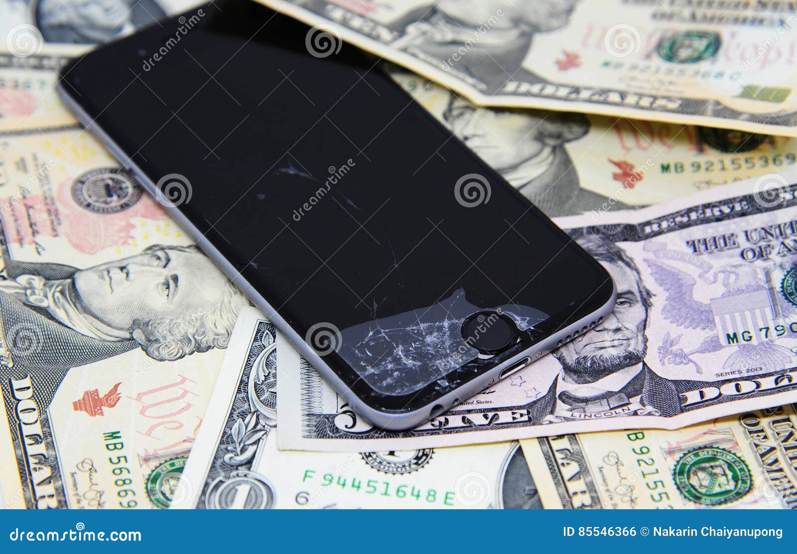 Broken smartphone on dollar banknotes, time to repair