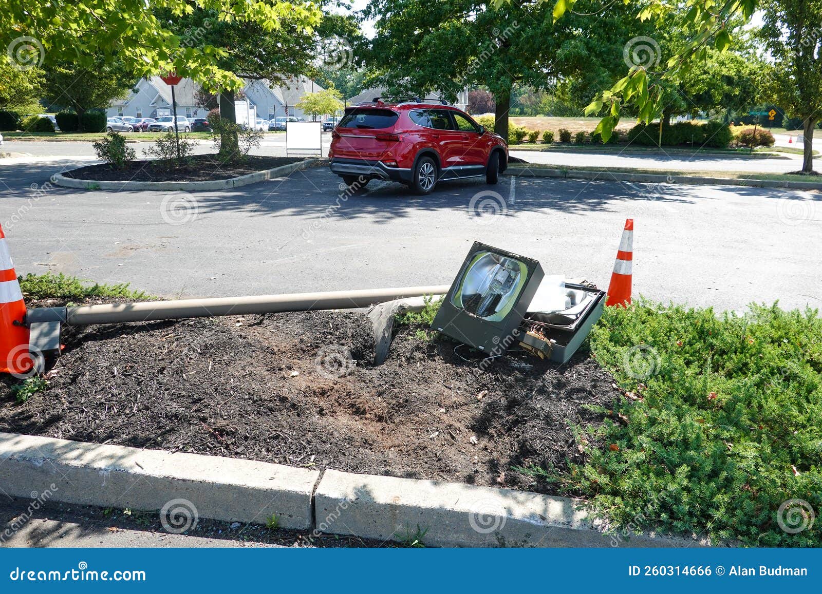 Broken Street Light Laying on the Ground in a Parking Lot Editorial