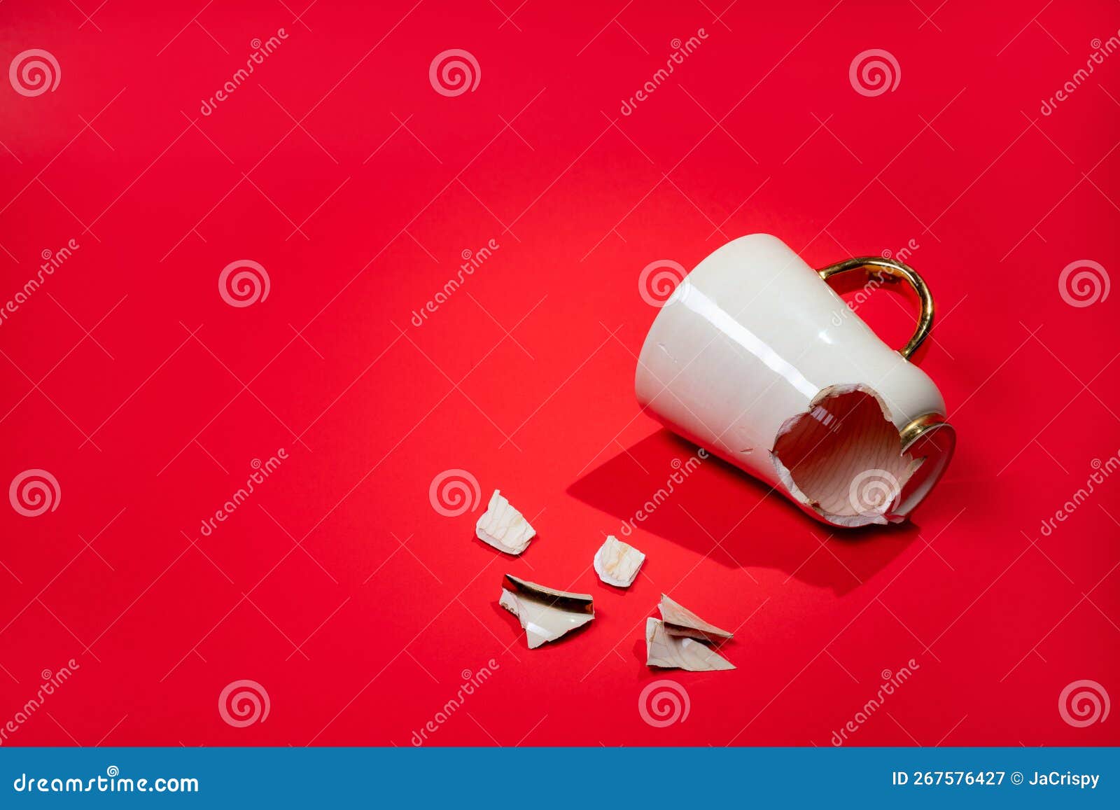 Broken Tea Cup Isolated on Red Background. Cracked Coffee Mug and Fragile Ceramic Pieces Stock