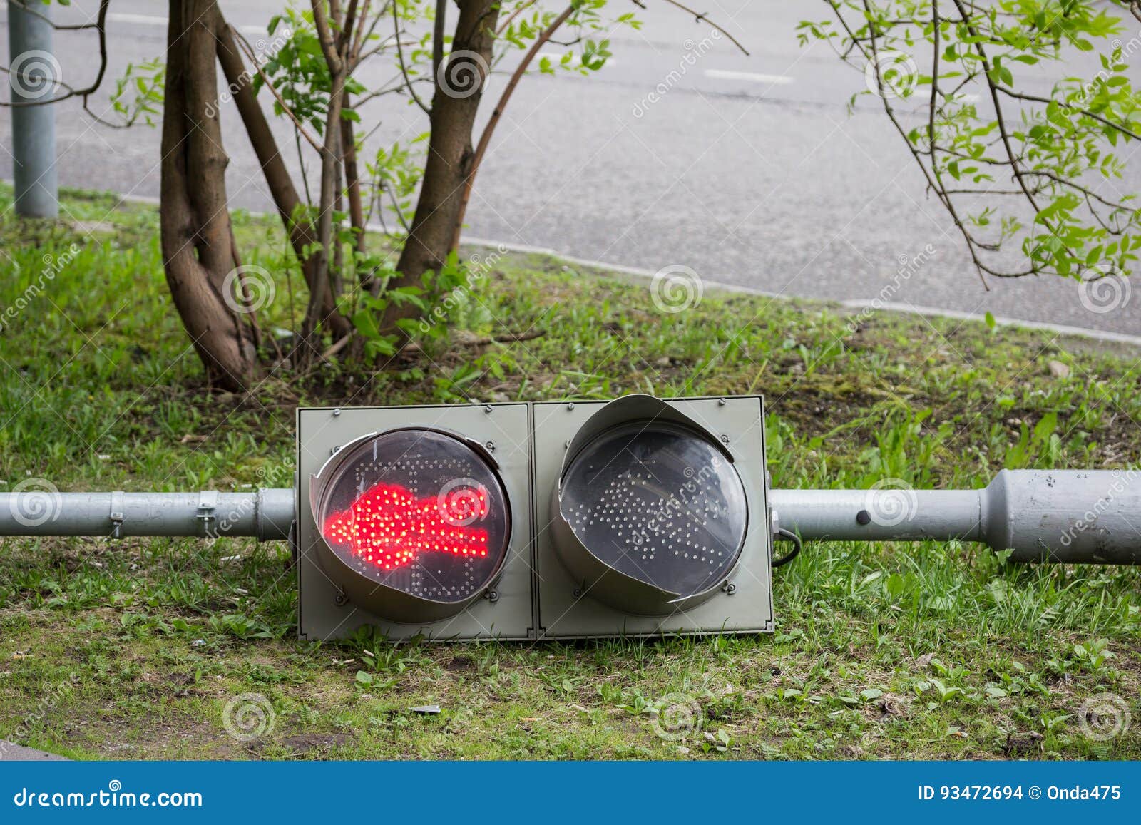 A Broken Traffic Light Lies on the Sidewalk. Stock Photo Image of