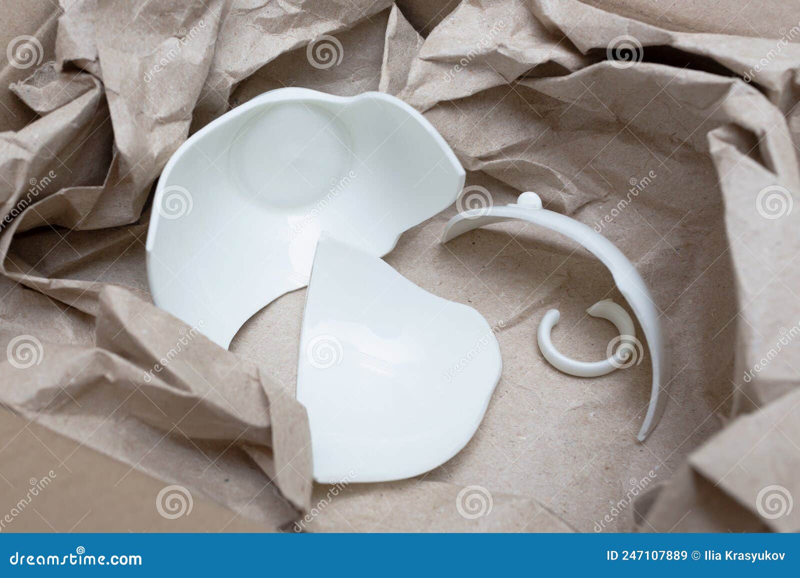 Broken White Cup in a Box with Packing Paper for Shipping. Close