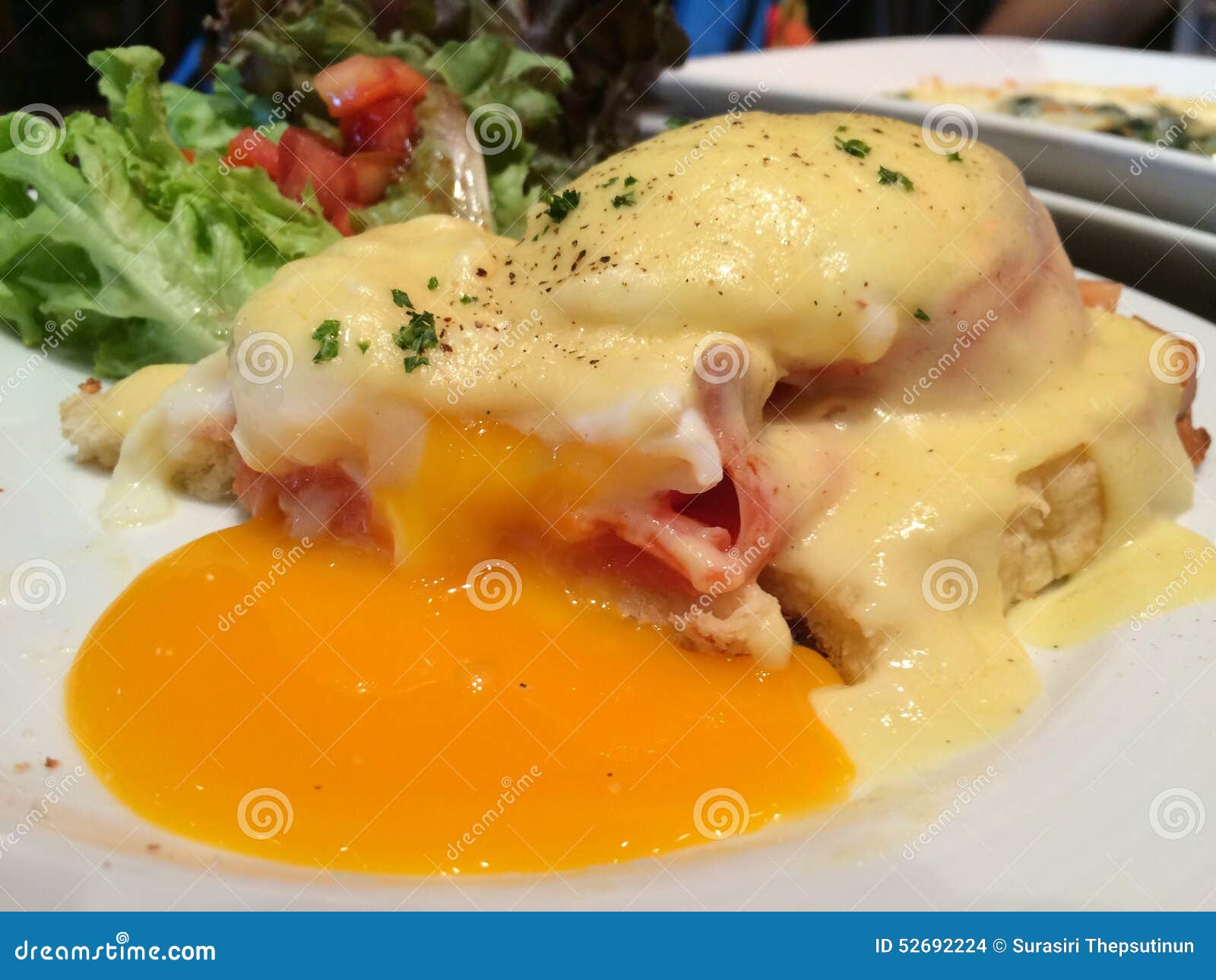 Broken yoke Eggs Benedict stock photo. Image of smoked 52692224