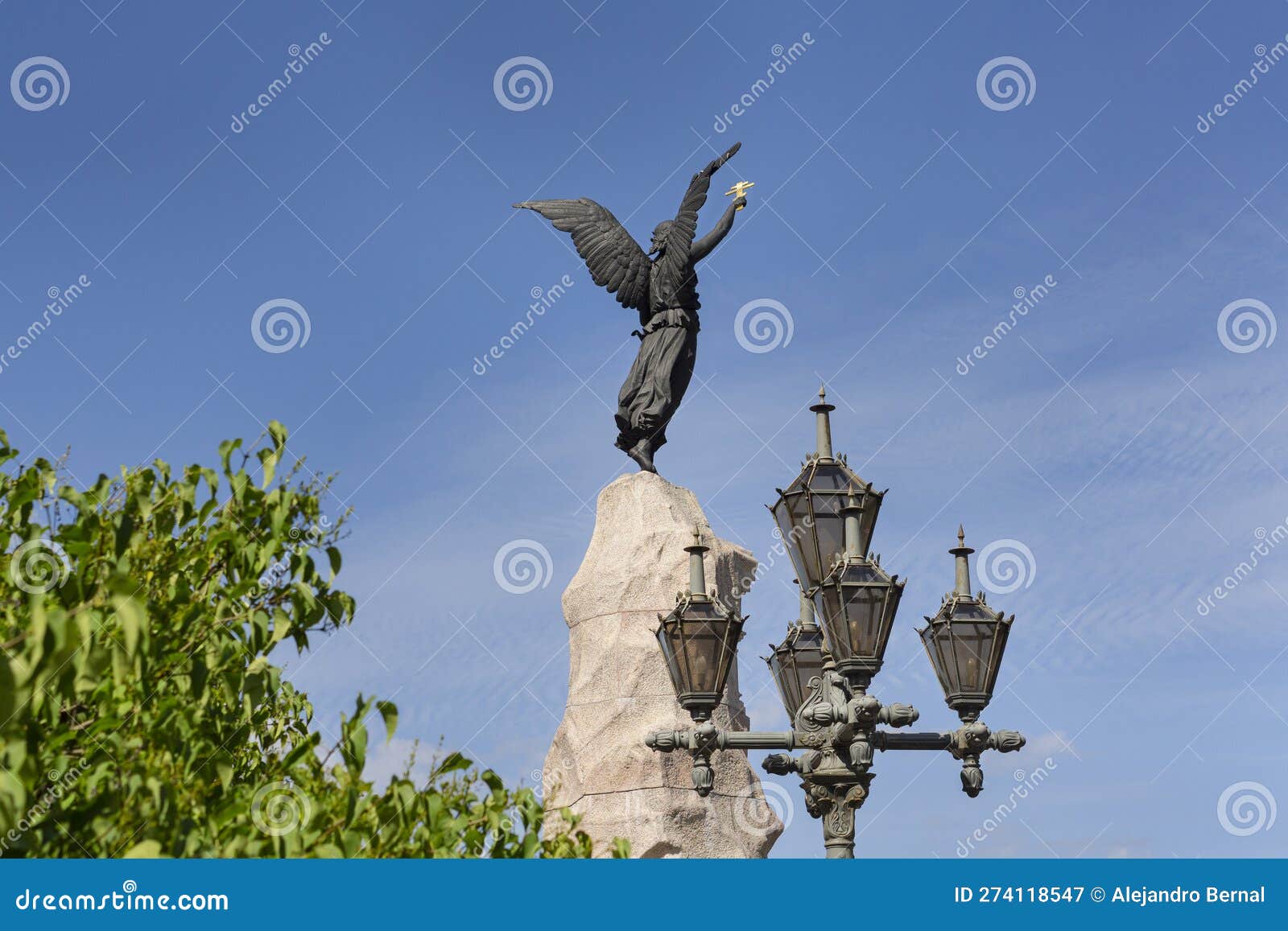 bronce angel sculpture of russalka monument with blue sky at background