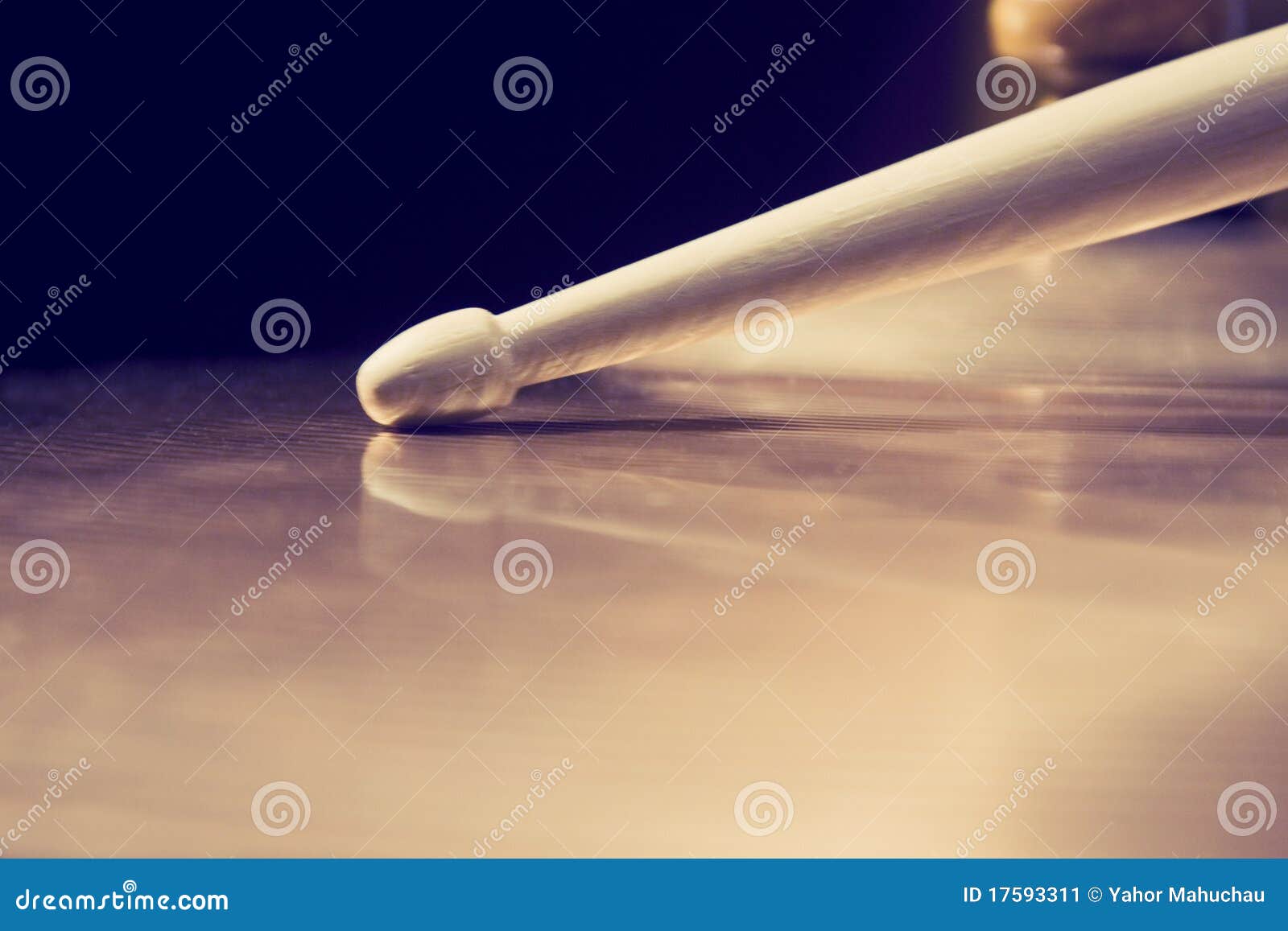 bronze brass cymbal close up with drumstick