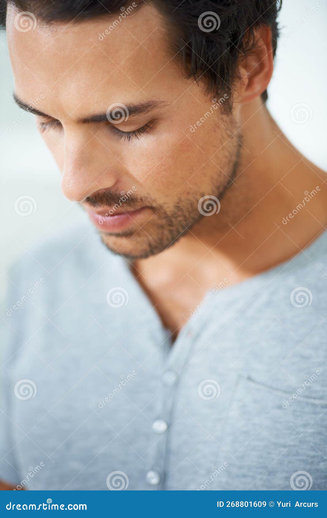 Brooding Manliness a Handsome Young Man Looking Down Thoughtfully Brooding Manliness a Handsome Young Man Looking Down Thoughtfully