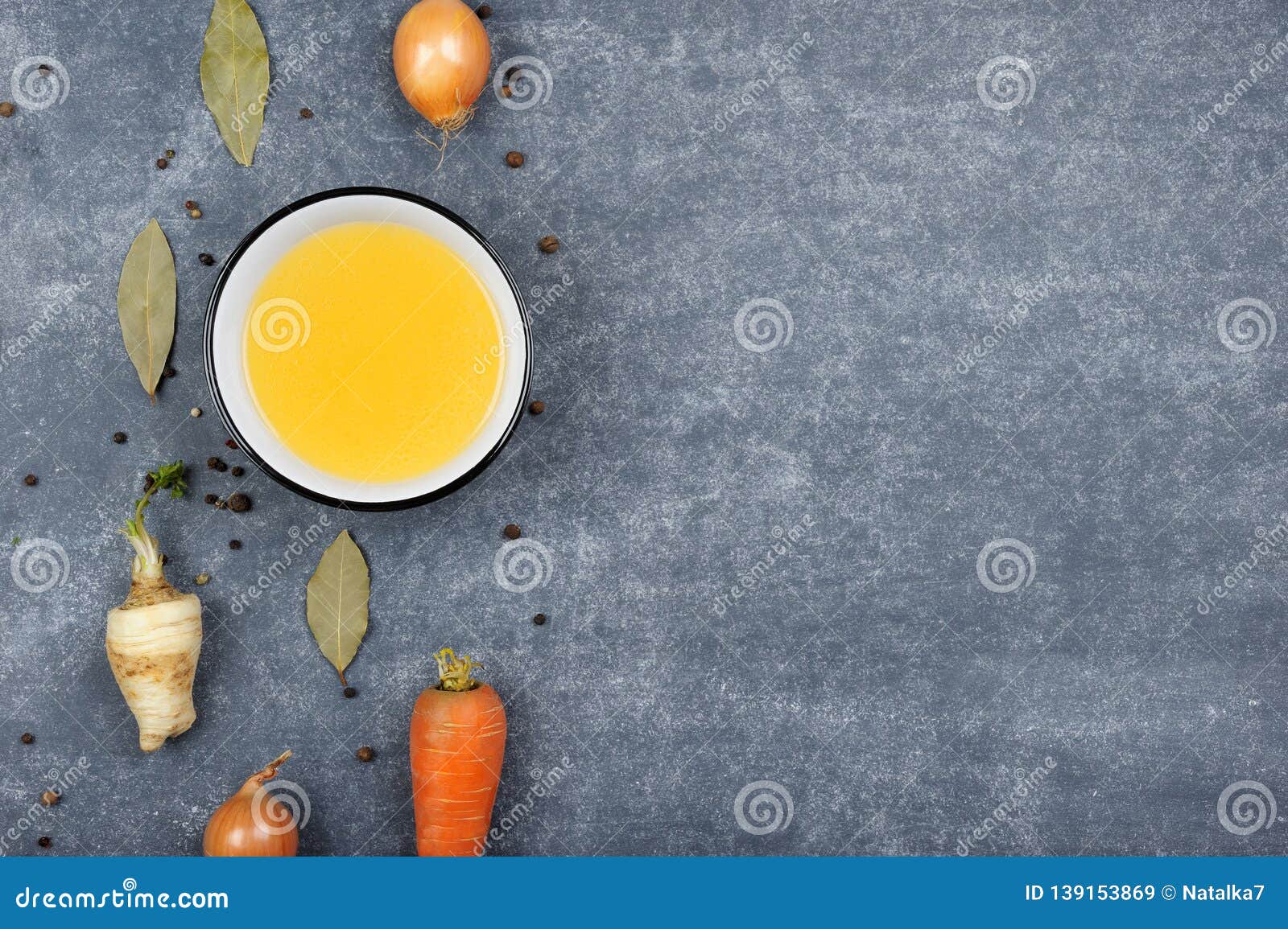 Homemade Broth or Bouillon in White Bowl on the Grey Background Stock