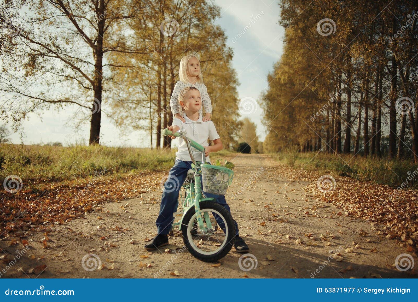 brother and sister at autumn road