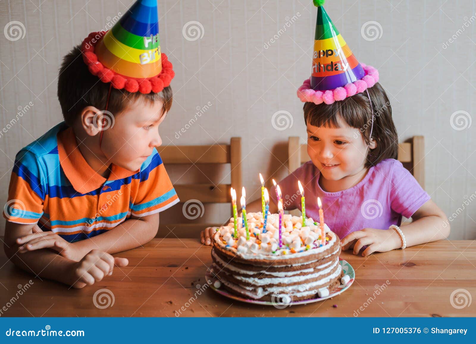 Brother and Sister Eating a Birthday Cake with Candles Blowing Out ...