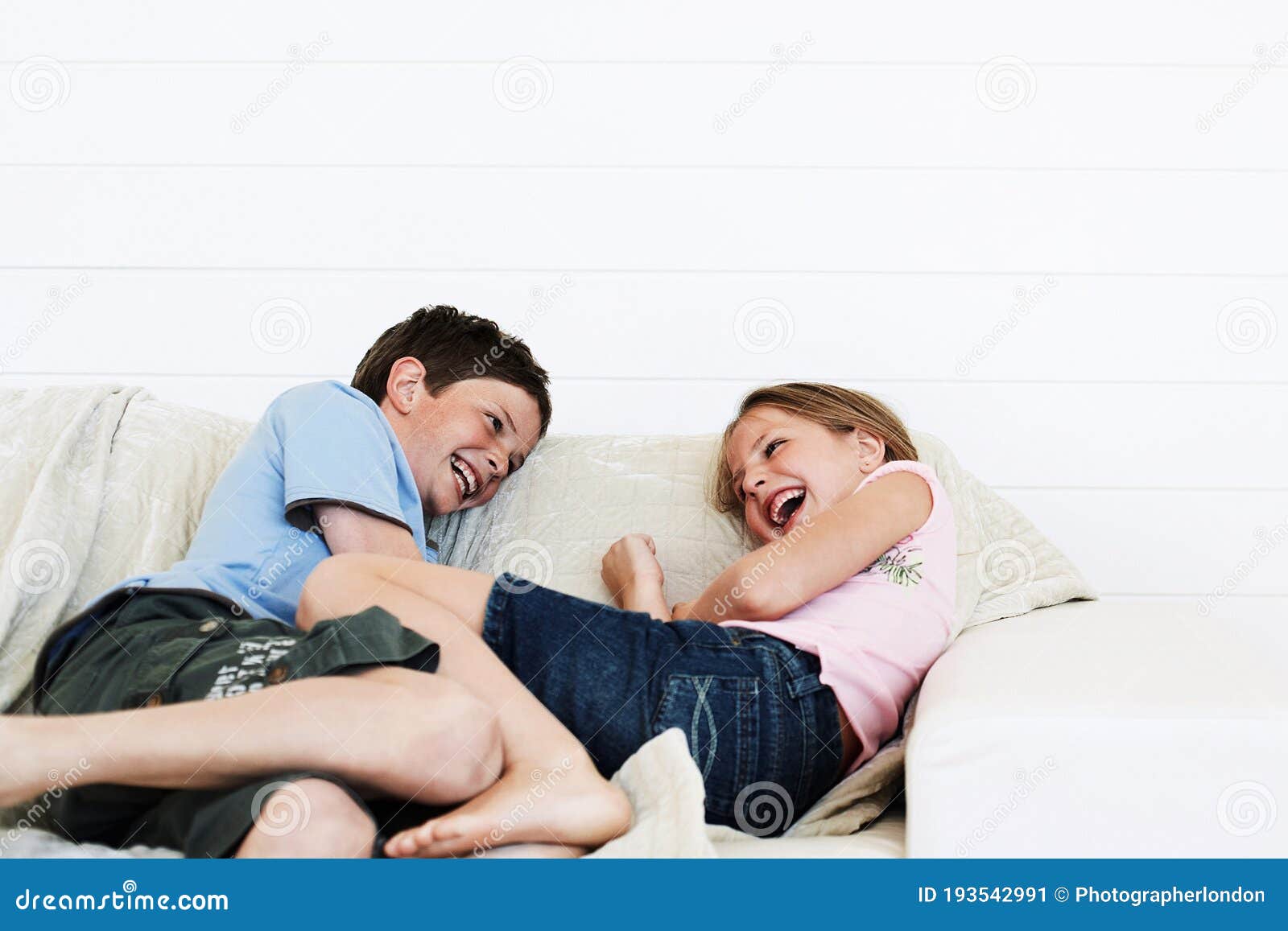 Brother And Sister Relaxing On Sofa Together Stock Image Image Of