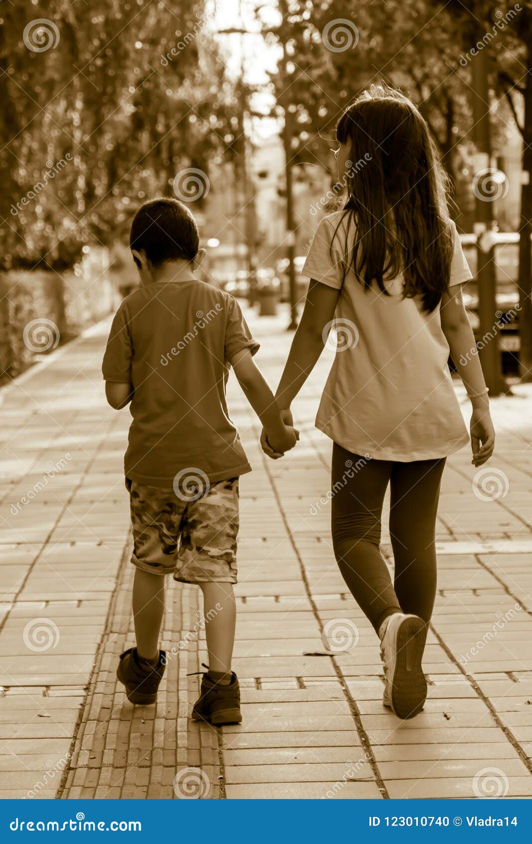 Brother and Sister Walking Down the Street. Holding Hands Stock ...