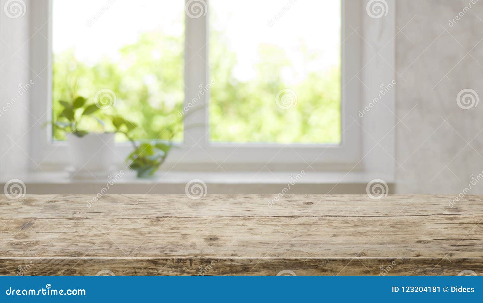 brown aged wooden tabletop with blurred window for product display