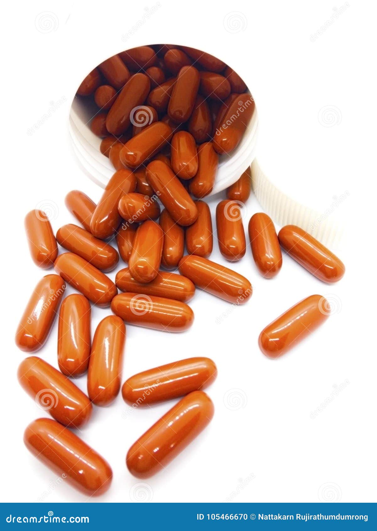 Brown Capsule Vitamins are Being Poured Out of White Plastic Bot Stock