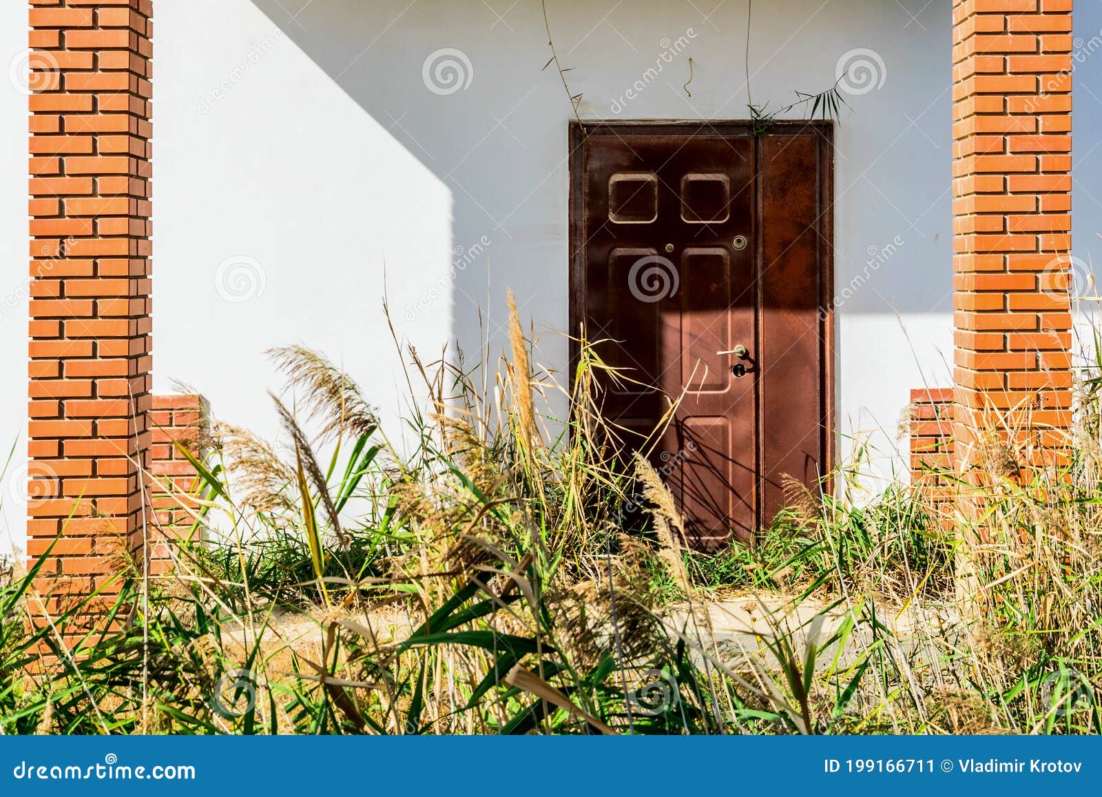 Brown door in white wall stock image. Image of front 199166711