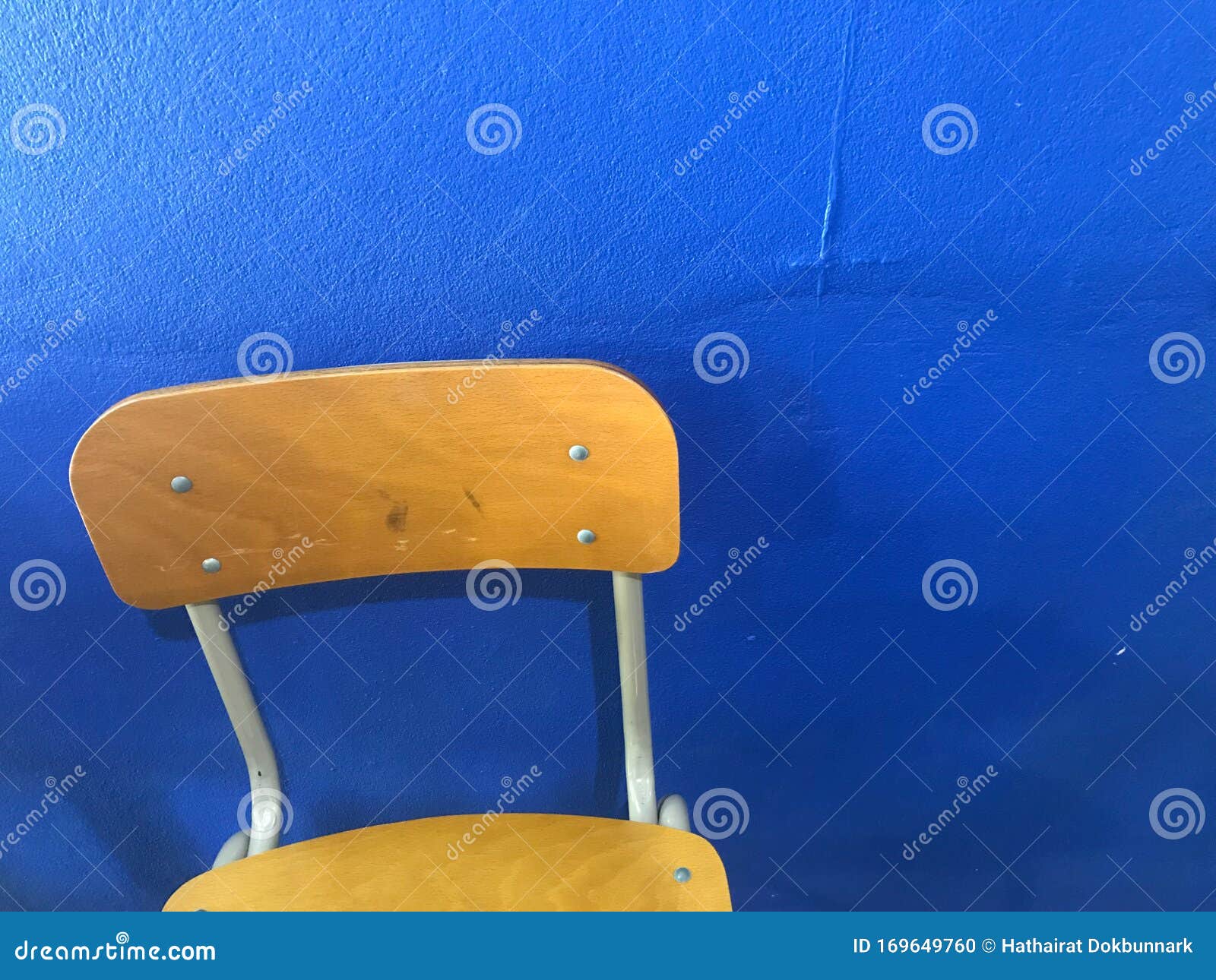 Brown Empty School Chairs with Blue Wall on Background Stock Photo