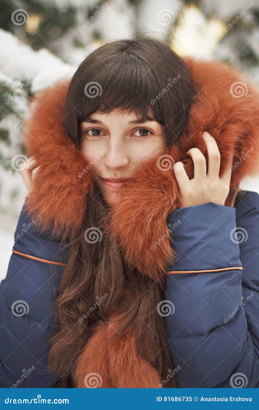Brown-haired Girl In The Hood With Fur Smiling On A Background Of Snow ...